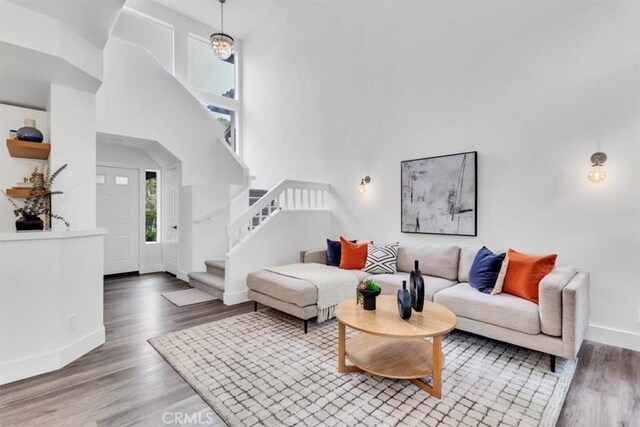 37 Conch Reef, Aliso Viejo, CA 92656 - living area featuring wood finished floors, stairs, and a towering ceiling