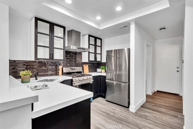 37 Conch Reef, Aliso Viejo, CA 92656 - kitchen with stainless steel appliances, wall chimney range hood, light countertops, backsplash, and recessed lighting