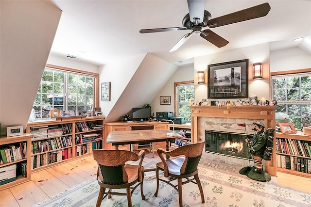 28971 N Shore Rd, Lake Arrowhead, CA 92352 - office space with lofted ceiling, a ceiling fan, a tiled fireplace, and hardwood / wood-style floors