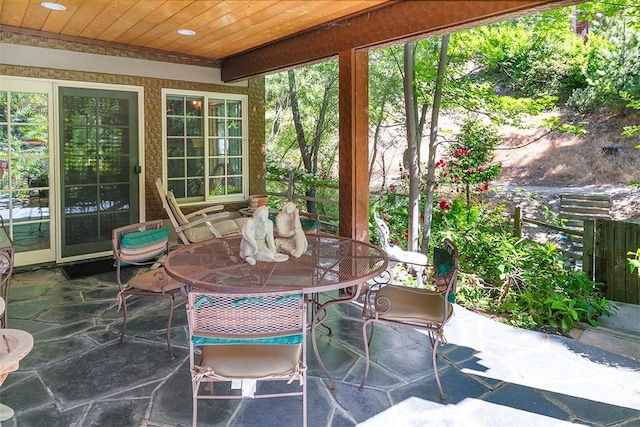 28971 N Shore Rd, Lake Arrowhead, CA 92352 - sunroom with wooden ceiling, stone finish flooring, recessed lighting, and outdoor dining area