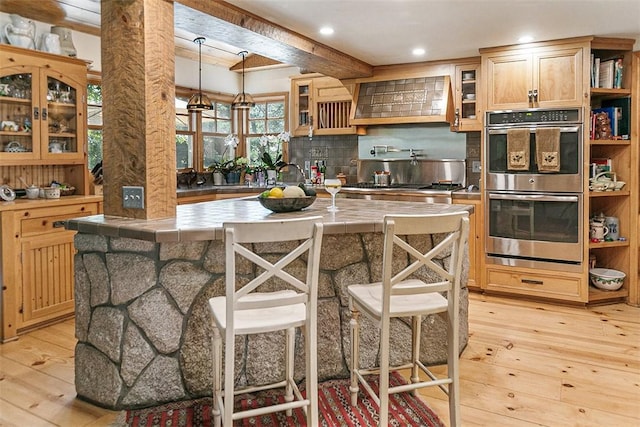 28971 N Shore Rd, Lake Arrowhead, CA 92352 - kitchen featuring stainless steel double oven, custom range hood, tile counters, light wood-style flooring, and recessed lighting