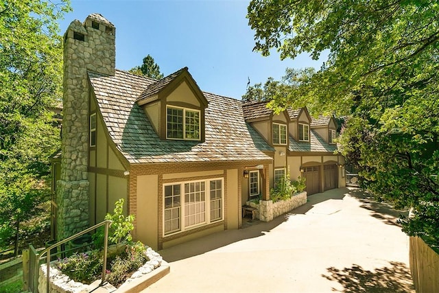 28971 N Shore Rd, Lake Arrowhead, CA 92352 - view of front of house featuring stucco siding and a chimney