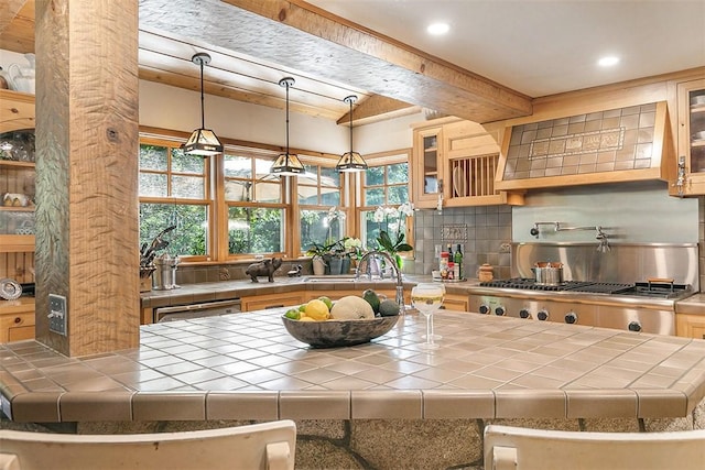 28971 N Shore Rd, Lake Arrowhead, CA 92352 - kitchen with tile counters, decorative backsplash, beam ceiling, a kitchen island, and glass insert cabinets