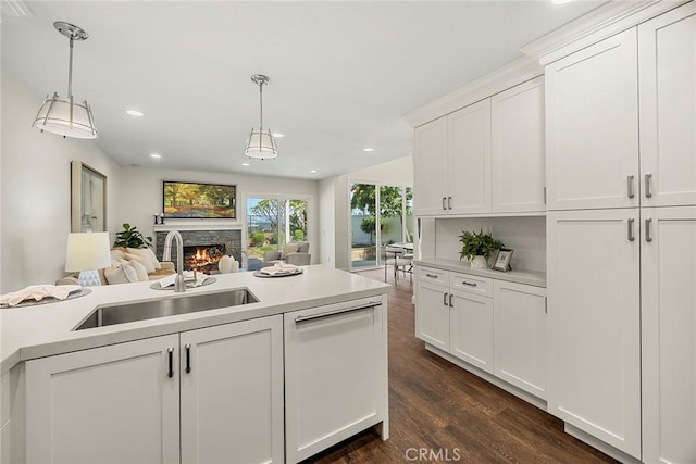28245 Via Alfonse, Laguna Niguel, CA 92677 - kitchen with a warm lit fireplace, light countertops, dark wood-style flooring, pendant lighting, and recessed lighting