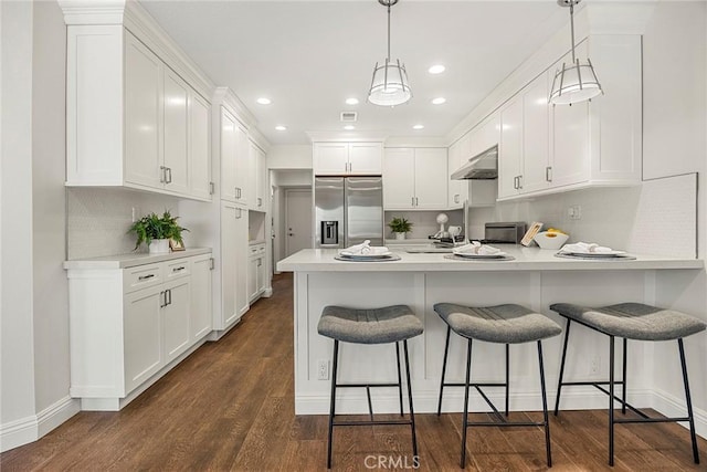 28245 Via Alfonse, Laguna Niguel, CA 92677 - kitchen featuring stainless steel refrigerator with ice dispenser, a peninsula, white cabinets, under cabinet range hood, and light countertops