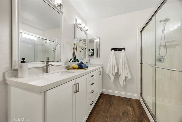 28245 Via Alfonse, Laguna Niguel, CA 92677 - bathroom featuring wood finished floors, tiled shower, and double vanity