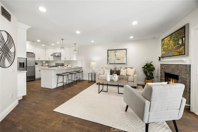 28245 Via Alfonse, Laguna Niguel, CA 92677 - living area with a stone fireplace, dark wood-style floors, and recessed lighting