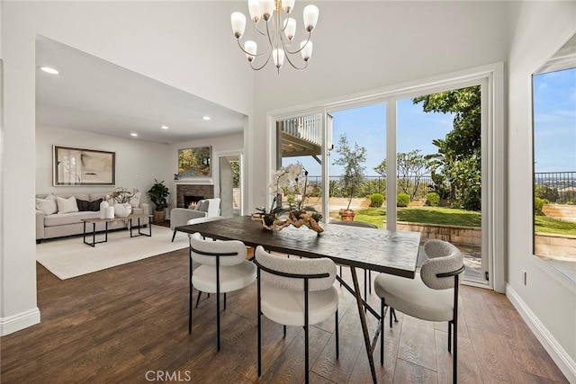 28245 Via Alfonse, Laguna Niguel, CA 92677 - dining area with wood finished floors, a warm lit fireplace, a chandelier, and recessed lighting