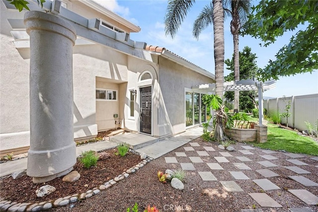 28245 Via Alfonse, Laguna Niguel, CA 92677 - doorway to property featuring a patio area, a pergola, and stucco siding