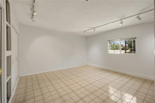 8291 Jennet St, Rancho Cucamonga, CA 91701 - spare room with track lighting and a textured ceiling