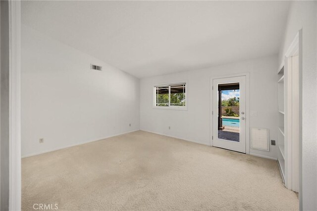 8291 Jennet St, Rancho Cucamonga, CA 91701 - empty room featuring light colored carpet and lofted ceiling