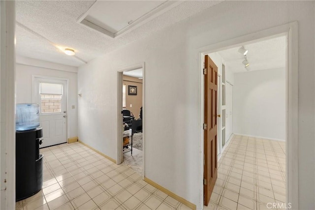 8291 Jennet St, Rancho Cucamonga, CA 91701 - corridor featuring a textured ceiling, rail lighting, and attic access