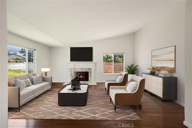 8291 Jennet St, Rancho Cucamonga, CA 91701 - living room featuring healthy amount of natural light, lofted ceiling, hardwood / wood-style floors, and a fireplace