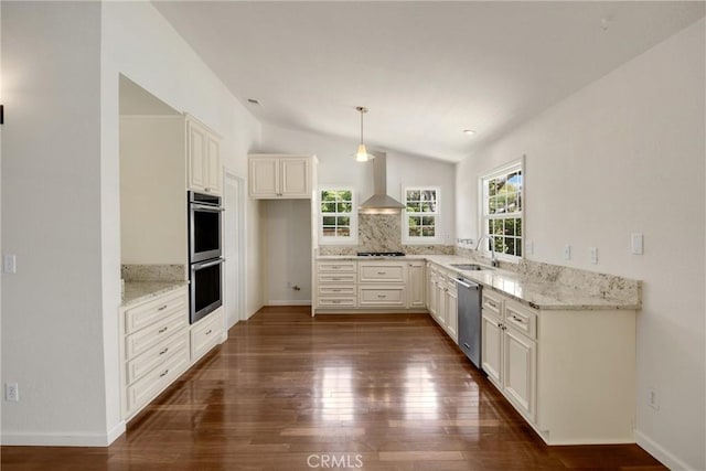 8291 Jennet St, Rancho Cucamonga, CA 91701 - kitchen with appliances with stainless steel finishes, wall chimney exhaust hood, vaulted ceiling, light stone counters, and dark wood-type flooring
