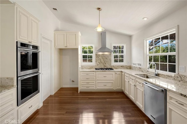 8291 Jennet St, Rancho Cucamonga, CA 91701 - kitchen with stainless steel appliances, wall chimney range hood, vaulted ceiling, dark wood finished floors, and plenty of natural light