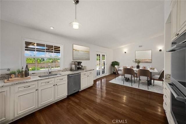 8291 Jennet St, Rancho Cucamonga, CA 91701 - kitchen with appliances with stainless steel finishes, dark wood-style flooring, light stone counters, pendant lighting, and white cabinetry