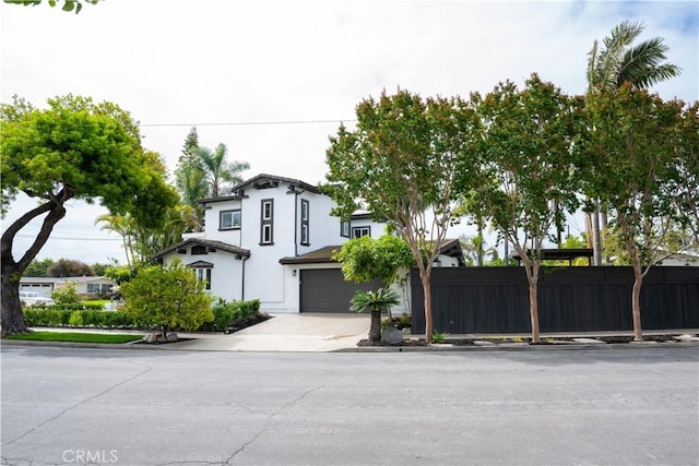 3119 Gibraltar Ave, Costa Mesa, CA 92626 - italianate-style house with concrete driveway, an attached garage, and stucco siding