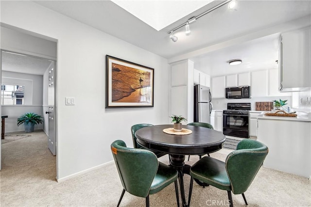 18051 Wakefield Ln Unit 106, Huntington Beach, CA 92648 - dining area featuring light carpet and rail lighting