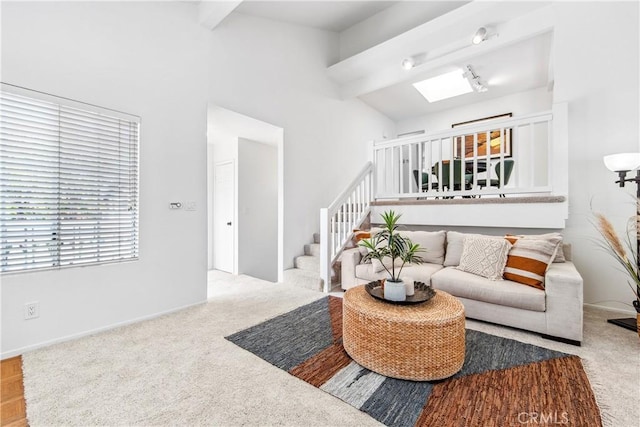 18051 Wakefield Ln Unit 106, Huntington Beach, CA 92648 - carpeted living area with beam ceiling, stairway, and a towering ceiling