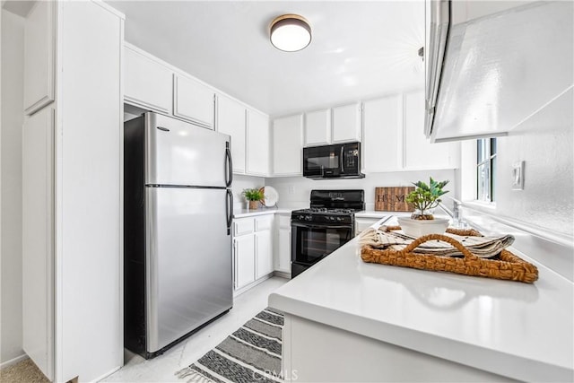 18051 Wakefield Ln Unit 106, Huntington Beach, CA 92648 - kitchen featuring black appliances, light countertops, and white cabinetry