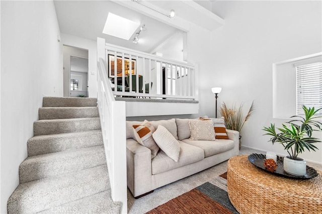 18051 Wakefield Ln Unit 106, Huntington Beach, CA 92648 - carpeted living area with stairway, a skylight, plenty of natural light, and vaulted ceiling