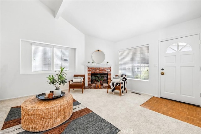 18051 Wakefield Ln Unit 106, Huntington Beach, CA 92648 - entrance foyer with a fireplace, beam ceiling, and high vaulted ceiling