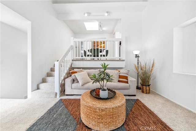18051 Wakefield Ln Unit 106, Huntington Beach, CA 92648 - living area with carpet flooring, stairs, and a skylight