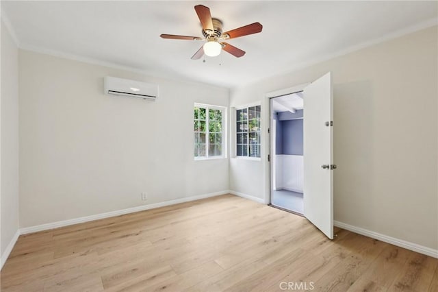 2422 E 115th St, Los Angeles, CA 90059 - unfurnished bedroom featuring a wall mounted AC, light wood-style floors, and a ceiling fan