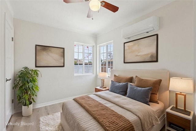 2422 E 115th St, Los Angeles, CA 90059 - bedroom featuring a wall unit AC, wood finished floors, and ceiling fan
