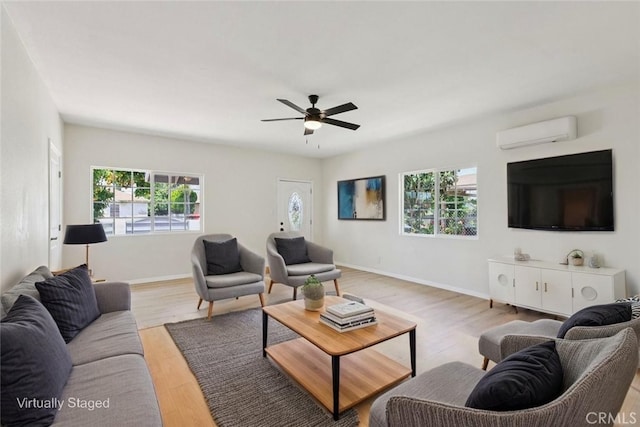 2422 E 115th St, Los Angeles, CA 90059 - living area featuring an AC wall unit, healthy amount of natural light, light wood-type flooring, and ceiling fan