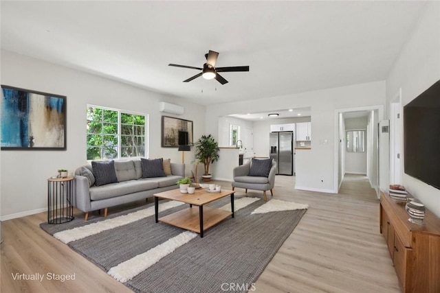 2422 E 115th St, Los Angeles, CA 90059 - living area with light wood-style floors, plenty of natural light, and ceiling fan