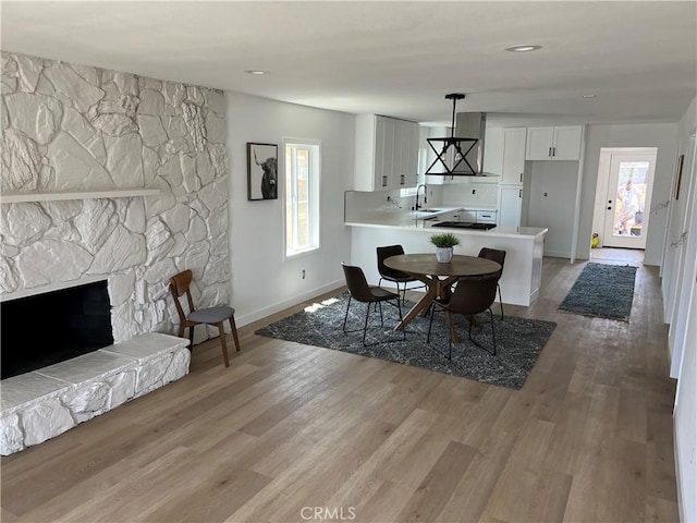 1350 Pleasant View Ave, Corona, CA 92882 - dining area featuring light wood-style floors and a stone fireplace