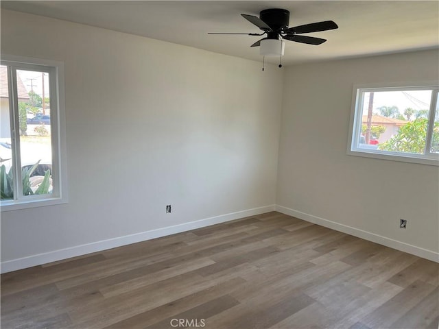 1350 Pleasant View Ave, Corona, CA 92882 - empty room with healthy amount of natural light, light wood-style floors, and a ceiling fan