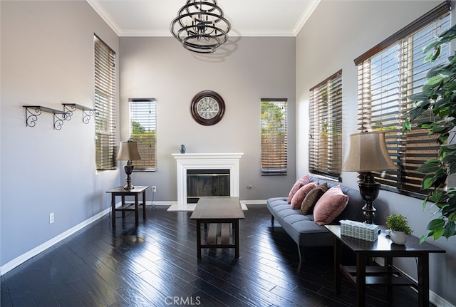 39269 Clear View Ct, Palmdale, CA 93551 - living room with a chandelier, wood-type flooring, a glass covered fireplace, ornamental molding, and a towering ceiling