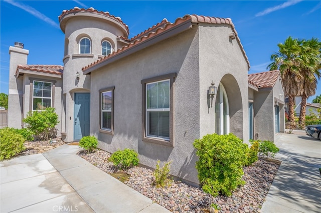 39269 Clear View Ct, Palmdale, CA 93551 - mediterranean / spanish home with a tiled roof, stucco siding, concrete driveway, a garage, and a chimney