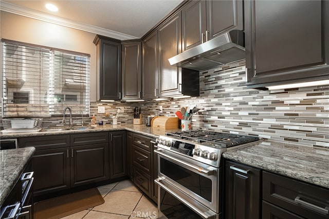 39269 Clear View Ct, Palmdale, CA 93551 - kitchen with range with two ovens, under cabinet range hood, crown molding, tasteful backsplash, and light tile patterned floors