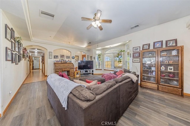 35095 Rough Rider Way, Raymond, CA 93653 - living area featuring arched walkways, wood finished floors, a ceiling fan, and a raised ceiling