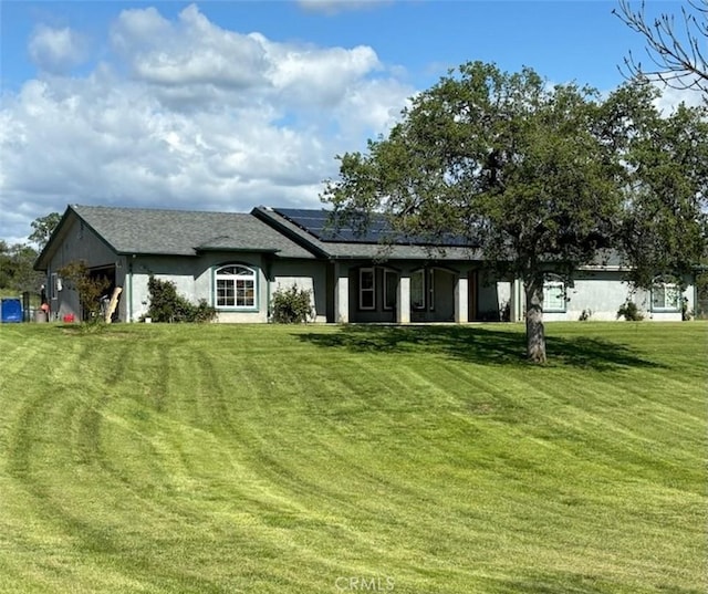 35095 Rough Rider Way, Raymond, CA 93653 - rear view of property featuring roof mounted solar panels and a yard