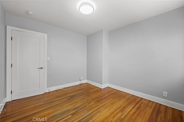 12950 7th St, Chino, CA 91710 - empty room with wood finished floors and a smoke detector