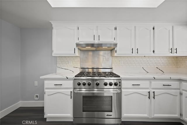 12950 7th St, Chino, CA 91710 - kitchen featuring stainless steel stove, under cabinet range hood, white cabinets, dark wood finished floors, and backsplash