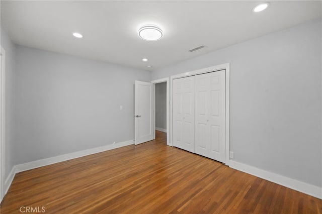 12950 7th St, Chino, CA 91710 - unfurnished bedroom featuring a closet, wood finished floors, and recessed lighting