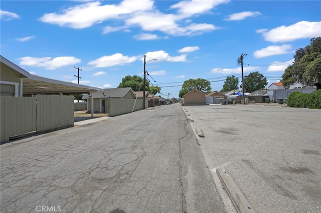 12950 7th St, Chino, CA 91710 - view of asphalt street featuring a residential view and street lighting