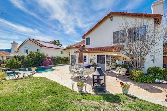 24813 Sagecrest Cir, Stevenson Ranch, CA 91381 - back of property featuring a tiled roof, stucco siding, a patio area, and an in-ground hot tub