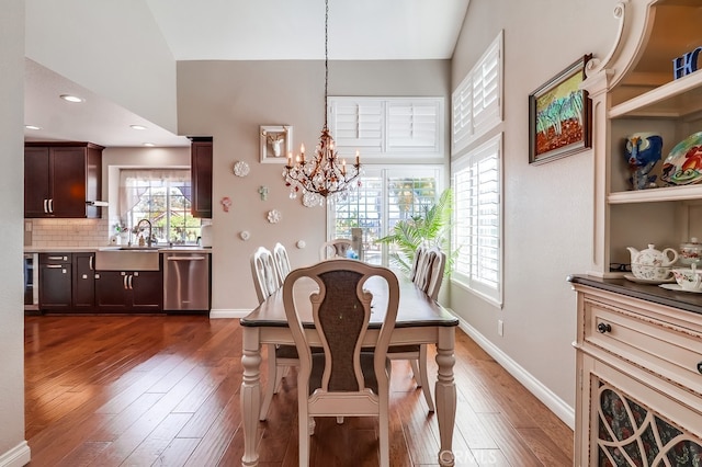 24813 Sagecrest Cir, Stevenson Ranch, CA 91381 - dining room featuring a chandelier, dark wood-style flooring, and lofted ceiling