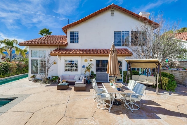 24813 Sagecrest Cir, Stevenson Ranch, CA 91381 - back of property with an outdoor living space, a patio, stucco siding, and a tiled roof