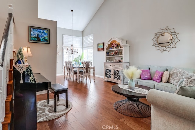 24813 Sagecrest Cir, Stevenson Ranch, CA 91381 - living room with high vaulted ceiling, a chandelier, and wood finished floors