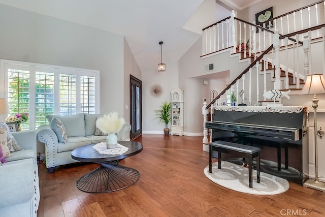 24813 Sagecrest Cir, Stevenson Ranch, CA 91381 - living area featuring high vaulted ceiling, wood finished floors, and stairs