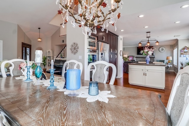24813 Sagecrest Cir, Stevenson Ranch, CA 91381 - dining area with recessed lighting, wood finished floors, a chandelier, and stairway