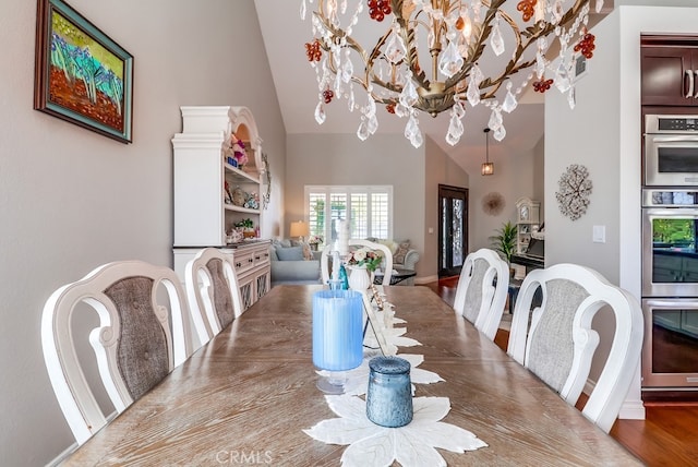24813 Sagecrest Cir, Stevenson Ranch, CA 91381 - dining room featuring high vaulted ceiling, a chandelier, and wood finished floors