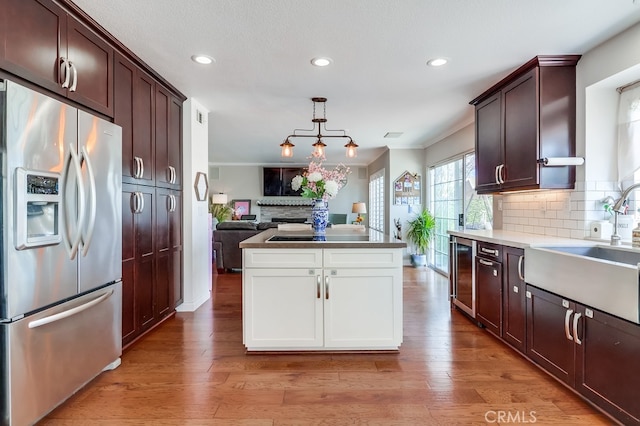 24813 Sagecrest Cir, Stevenson Ranch, CA 91381 - kitchen featuring stainless steel fridge with ice dispenser, ornamental molding, recessed lighting, decorative backsplash, and dark brown cabinets